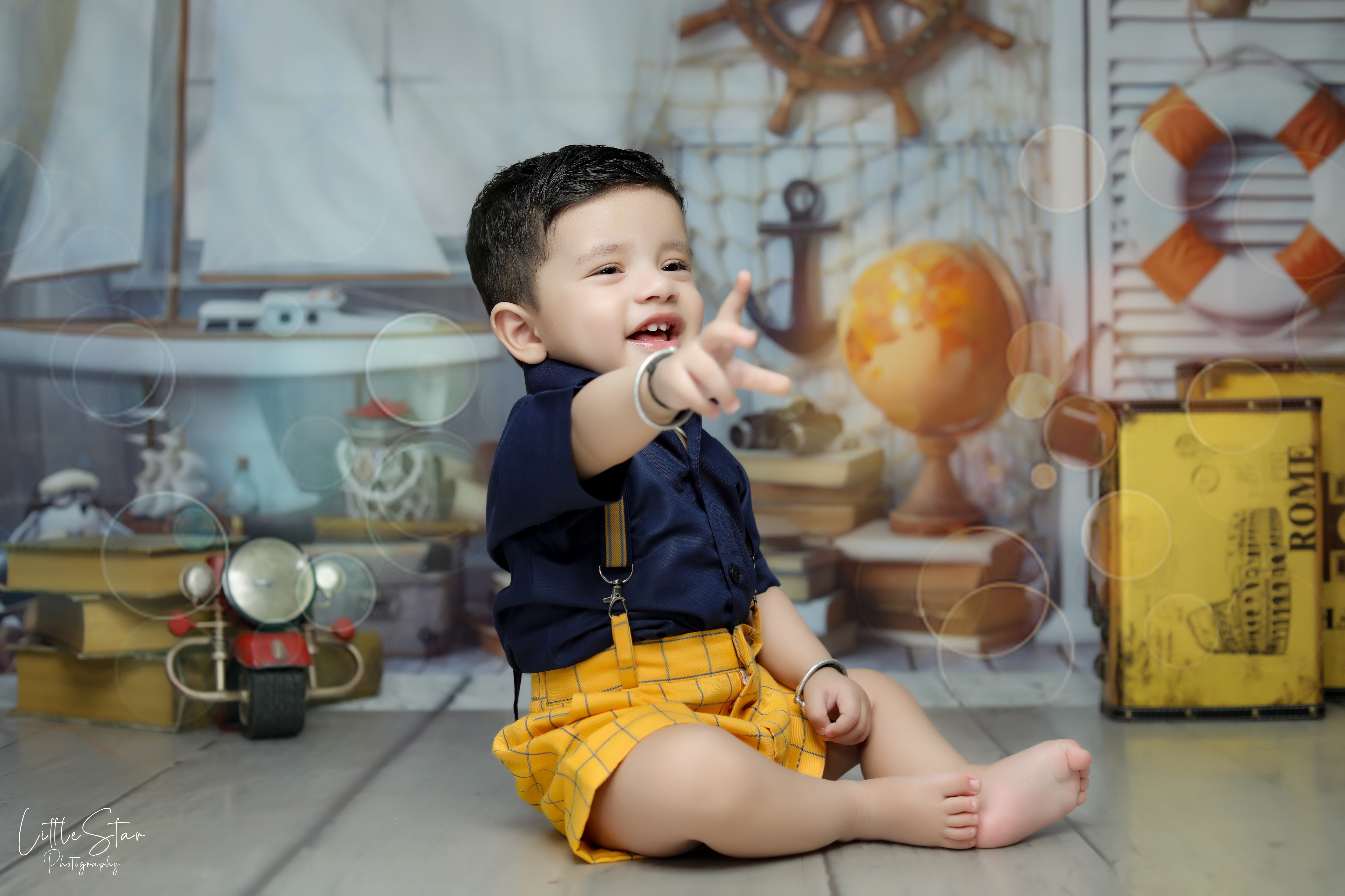 Adorable baby smiling during a professional baby photoshoot in Delhi, captured with soft lighting and a cozy setup to preserve precious early memories